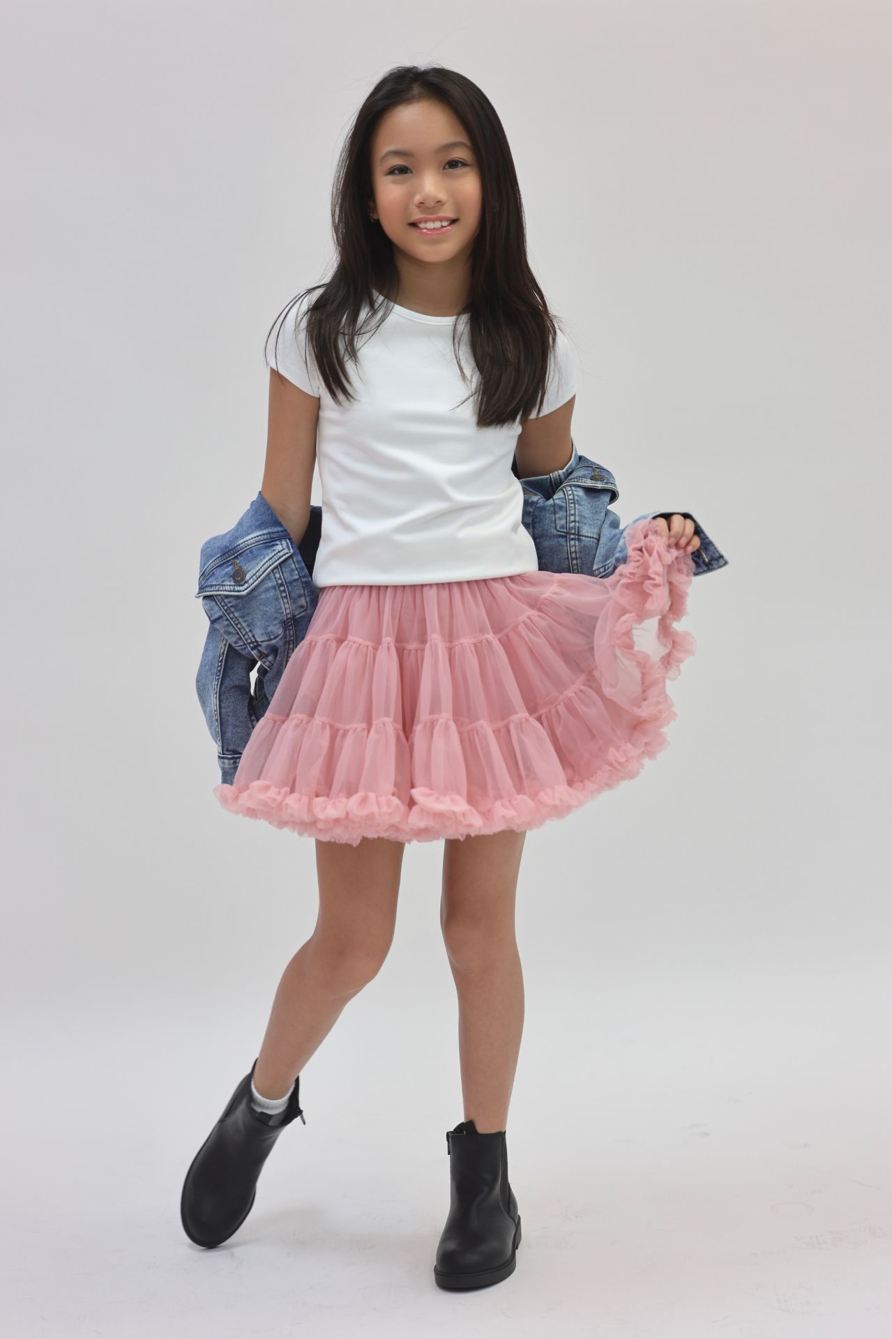 White tee and pink tulle skirt playful pose