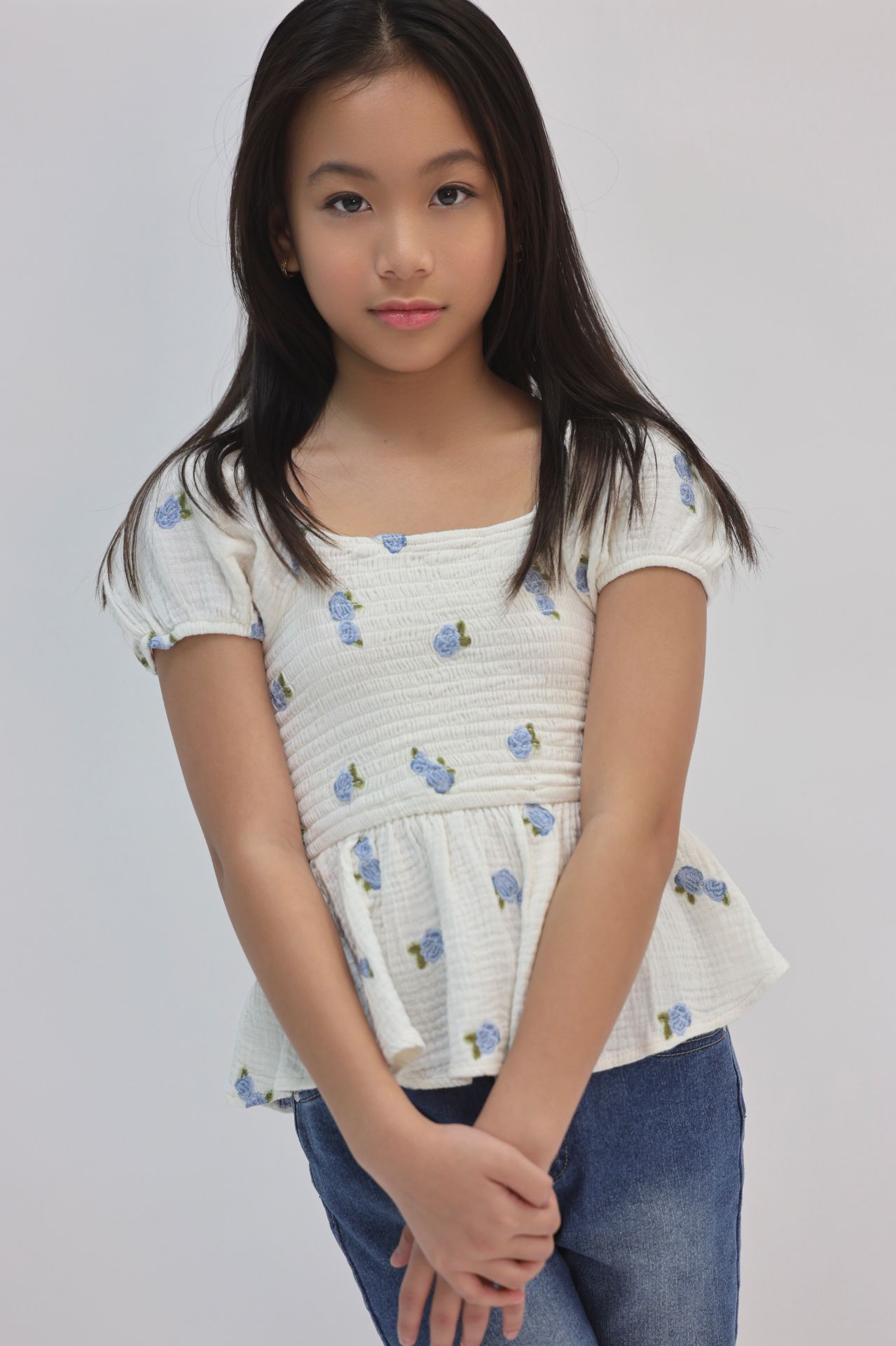 Bright commercial three-quarter smile in floral peplum top