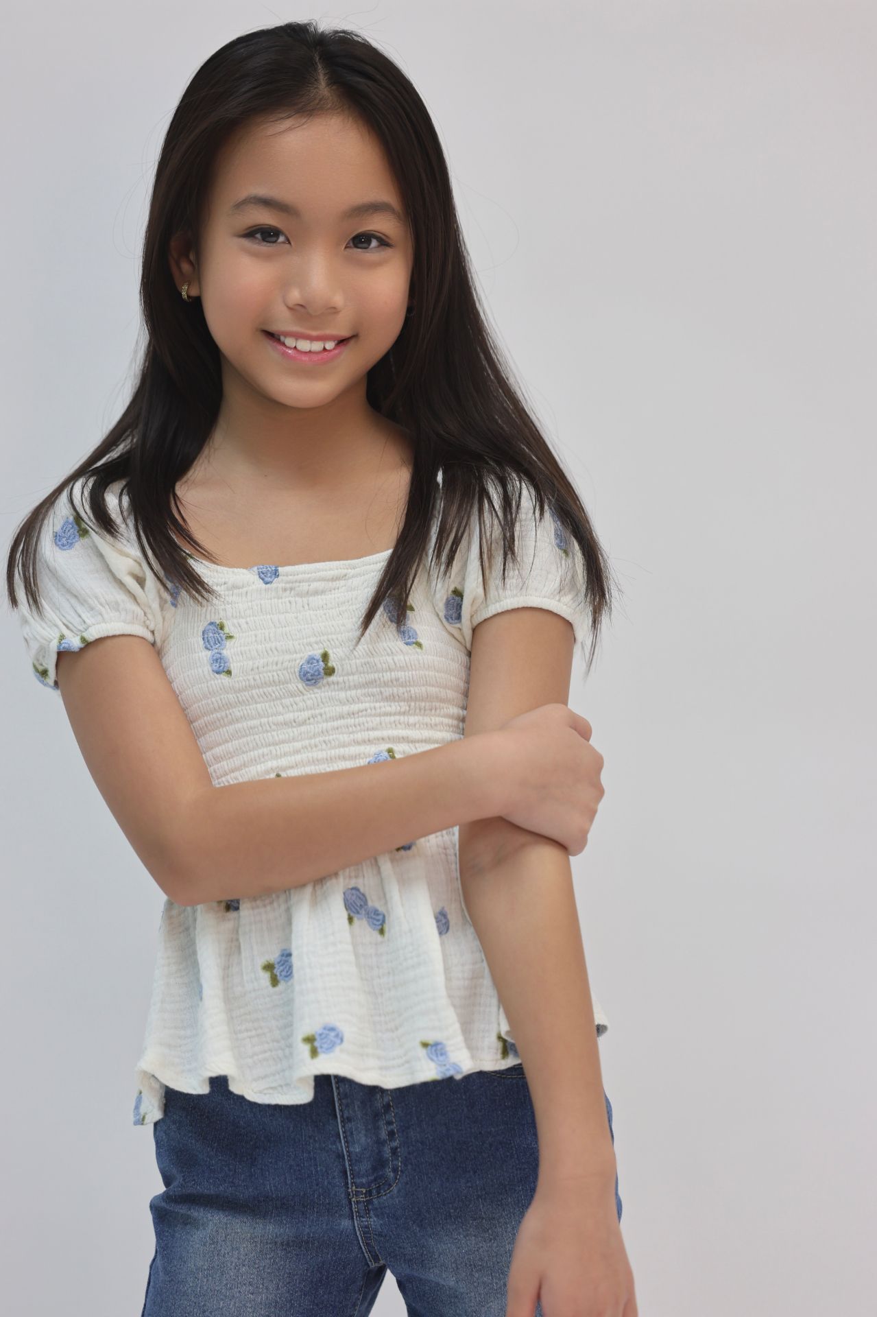 Commercial portrait with hands clasped in floral peplum top