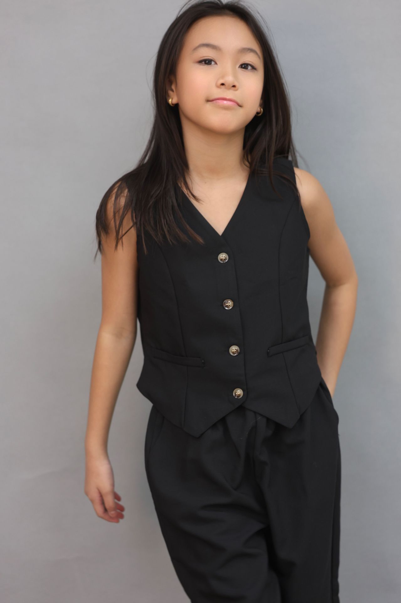 Full-length editorial in black vest and wide-leg trousers