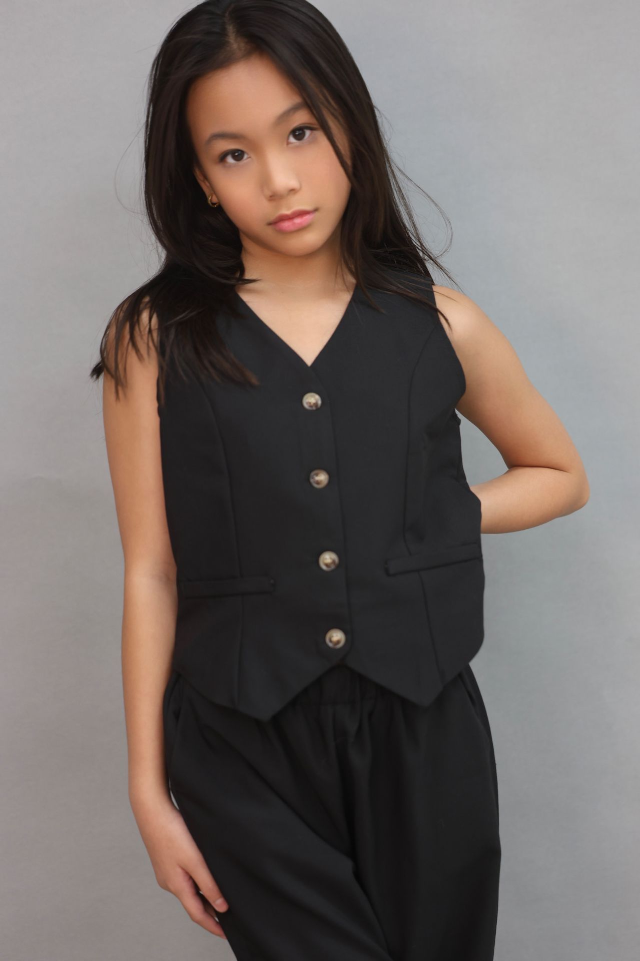 Editorial three-quarter pose in black tailored vest
